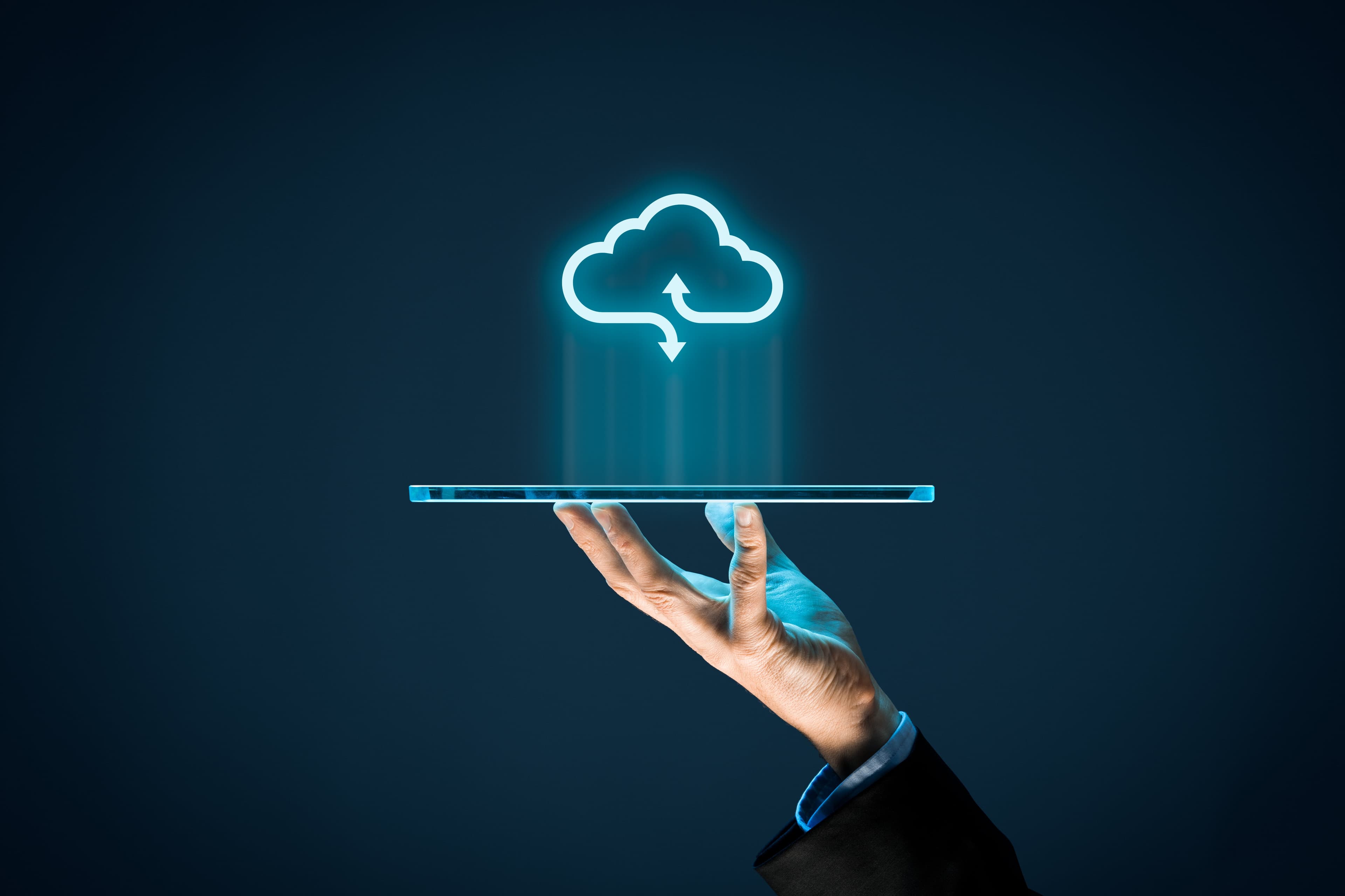 A professional team collaborating around cloud, data, and AI interface visuals in a bright office.